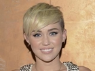 Miley Cyrus Poses Seductively In Jersey and High Heels